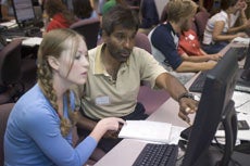 student and professor at computer