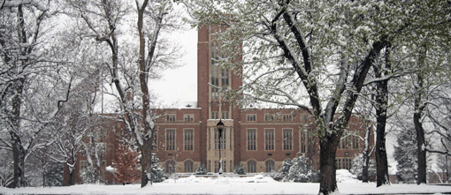 Mary Reed, the University's main administration building, under the blanket of freshly fallen spring snow