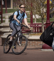 Student biking across campus.