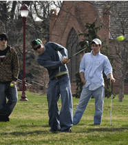 Student playing tennis ball golf.