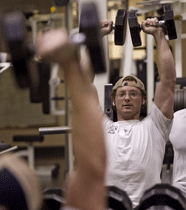 Student lifting weights.