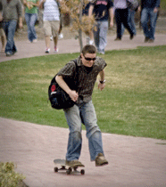 Student skateboarding across campus.