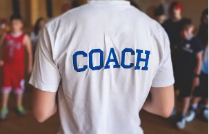 A person wearing a shirt that says COACH