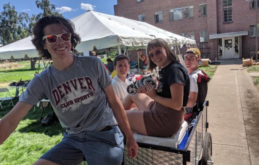 students riding a cargo bike from the center for sustainability