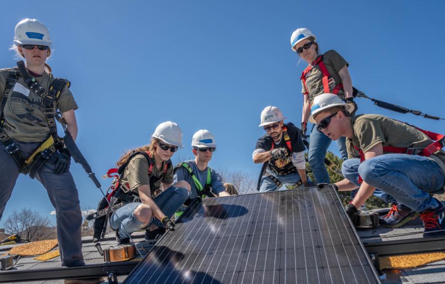 students installing solar panels