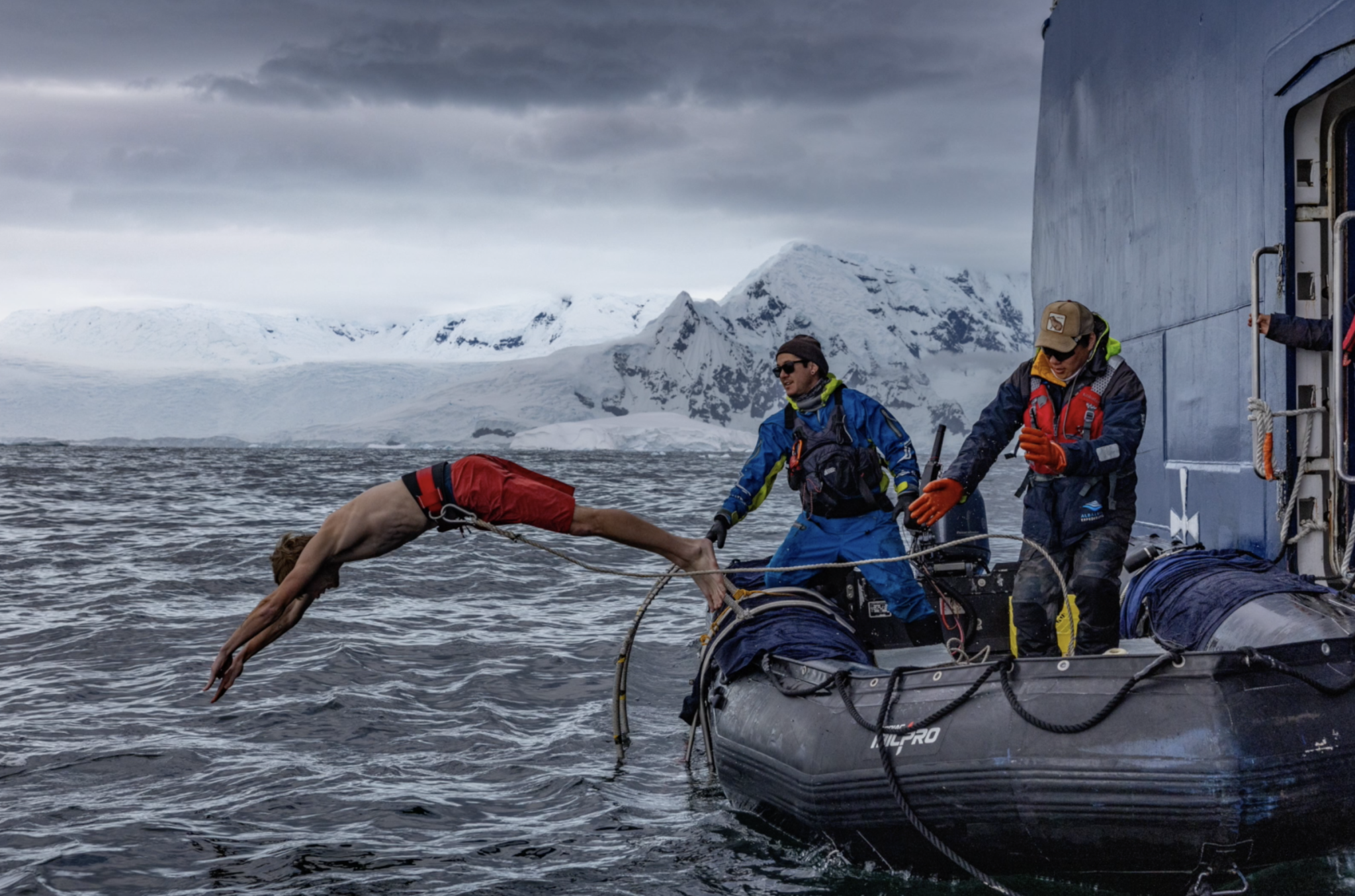 A student jumps off a raft for a cold plunge into the Antarctic waters.
