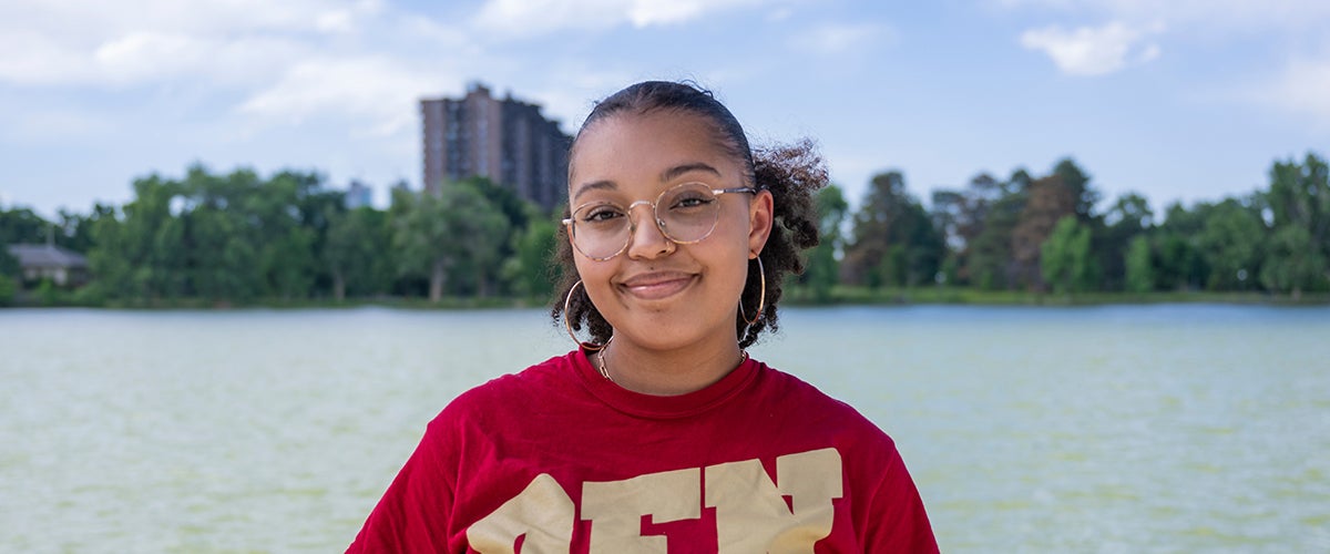 student smiling outside