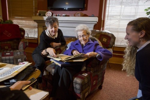 Rosemary McGibbon, 100, looks over her class yearbook from 1940.
