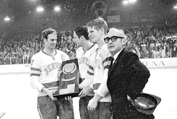 Craig Patrick, Tom Miller, Keith Magnuson and Murray Armstrong with the 1969 national championship trophy.