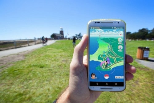 hand-holding-phone-using-pokemon-go-app