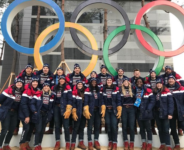 Tyler Dabrowski and the U.S. speed skating team pose for a picture with the Olympic rings in South Korea.