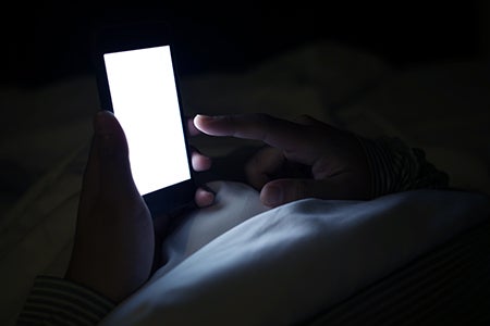 A person using a phone in a dark room
