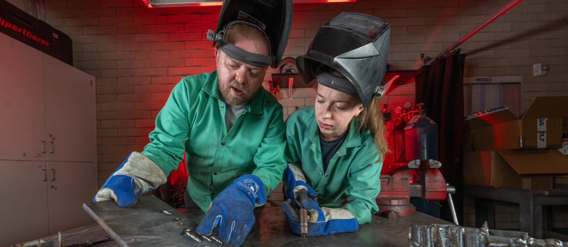 a student and a faculty in a DU metal welding workshop