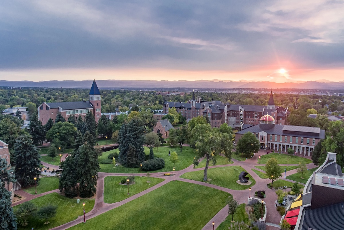 view of DU campus with sun setting over the Rocky Mountains