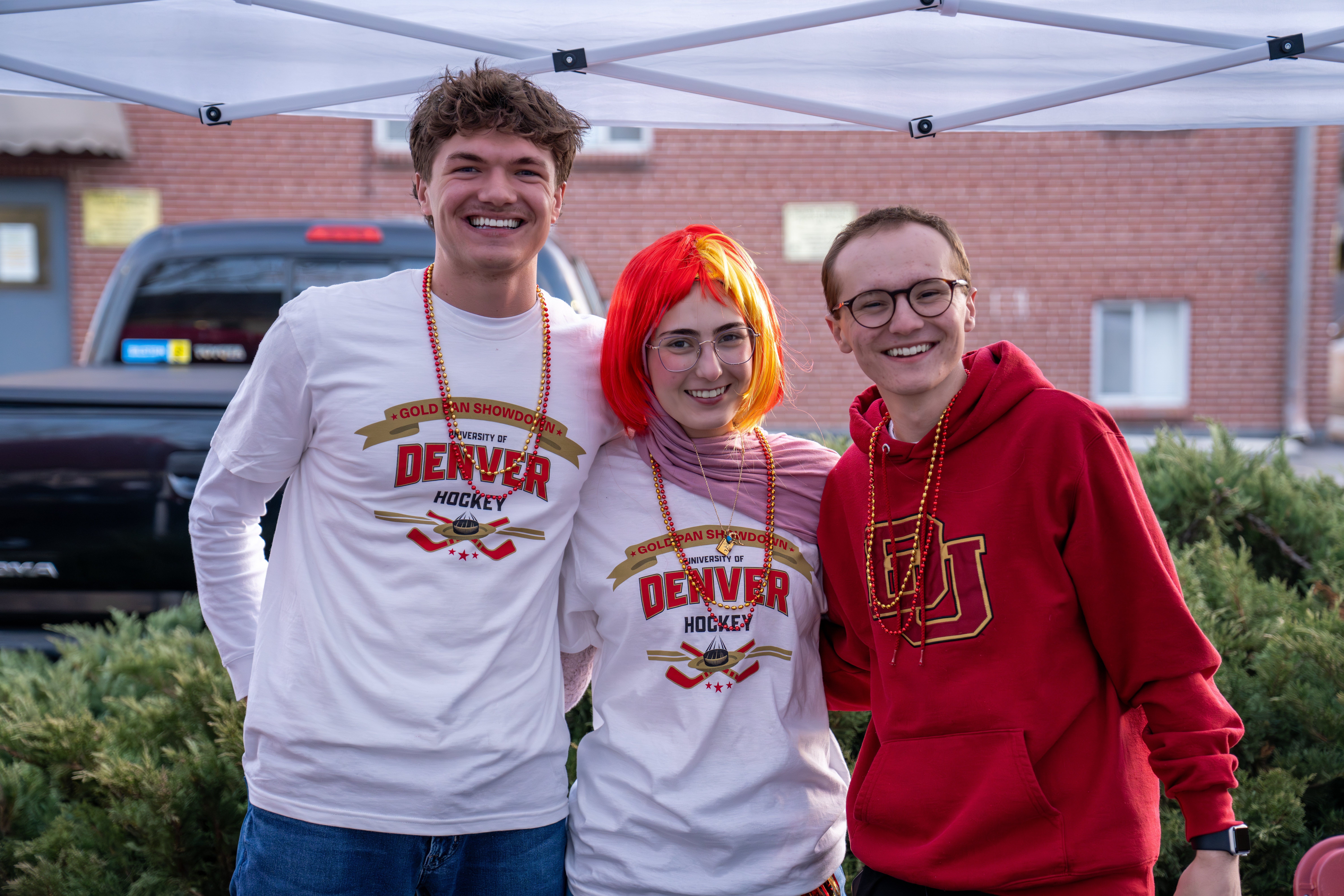 students pose at hockey tailgate party