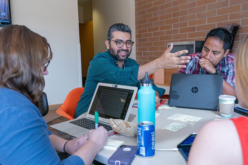 a group of students discuss and study