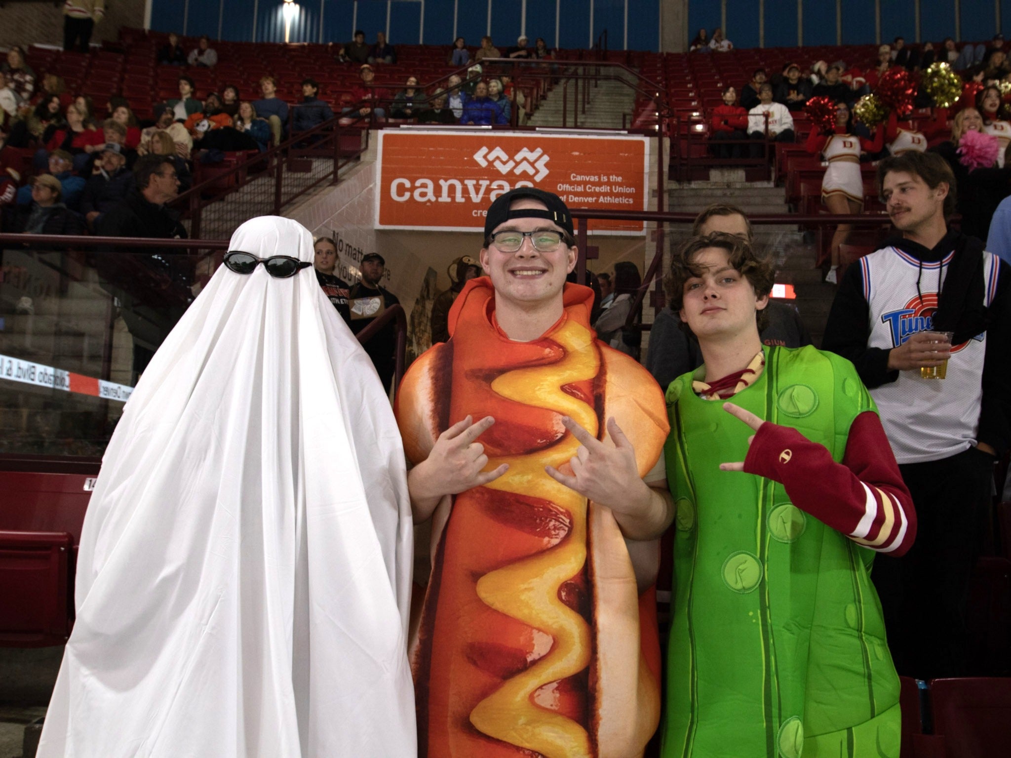 two students dressed up as hot dog and pickle, and a student dressed up as a ghost