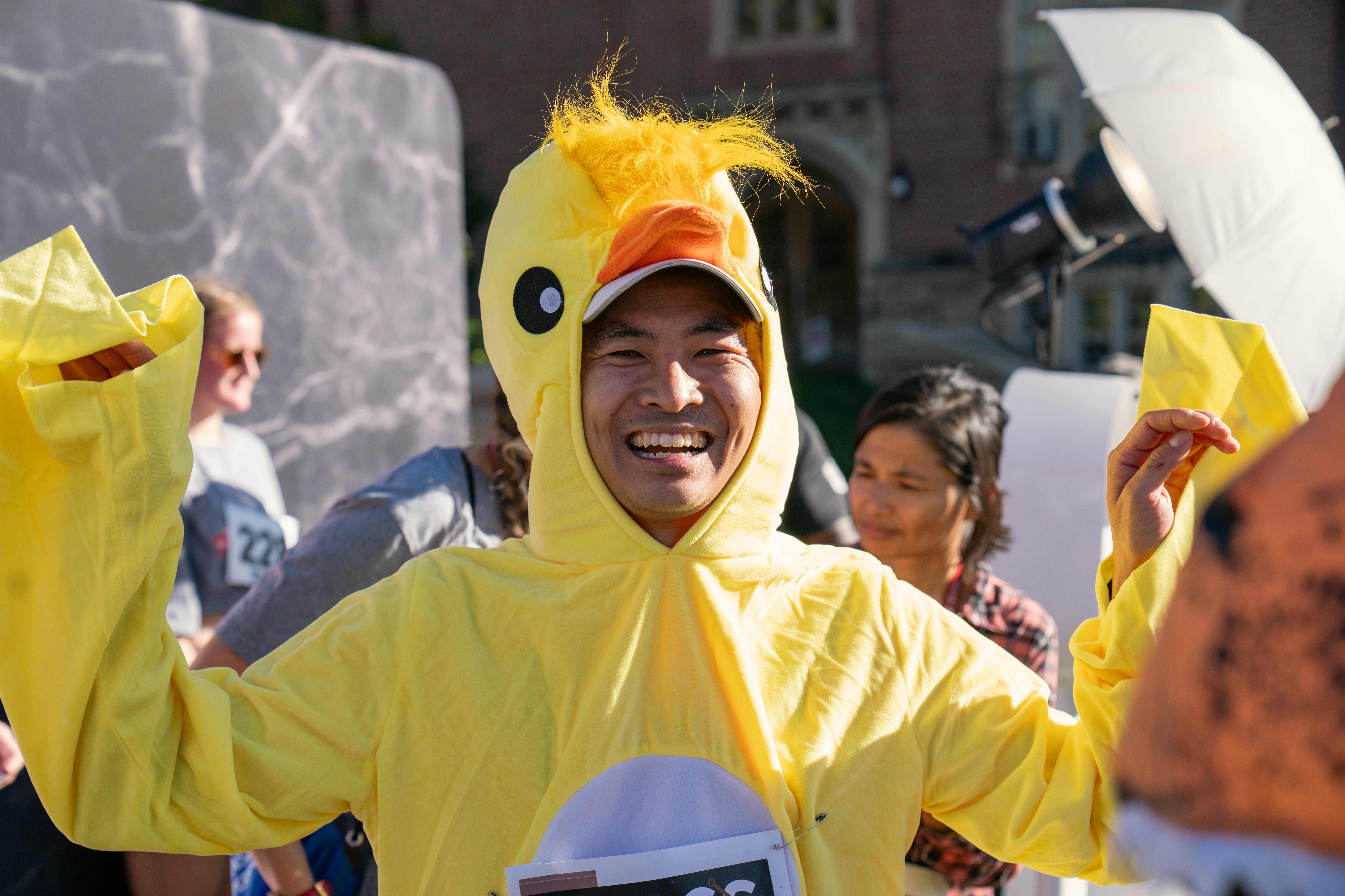 a person dressing in yellow duck costume running crimson classic 5k