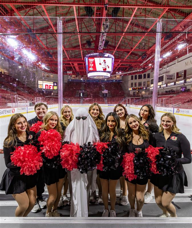 cheerleaders and a student dressed up as a ghost at magness arena