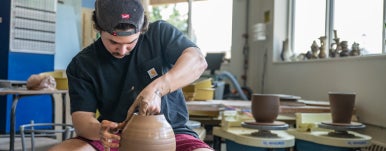 a student working on pottery project