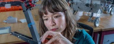 A student is working on a drone at drone lab