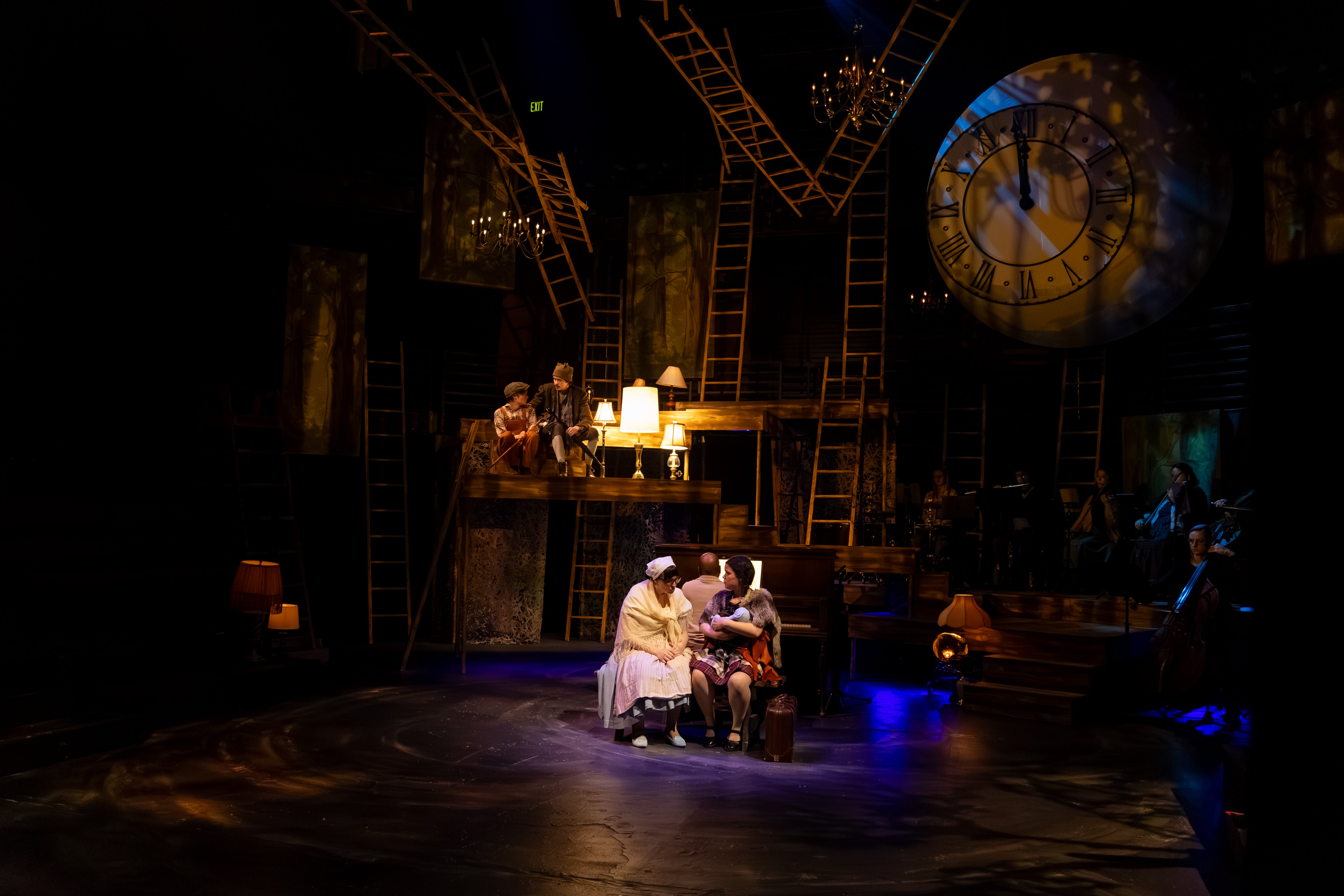 Actors sit on different levels of the "Into the Woods" set.