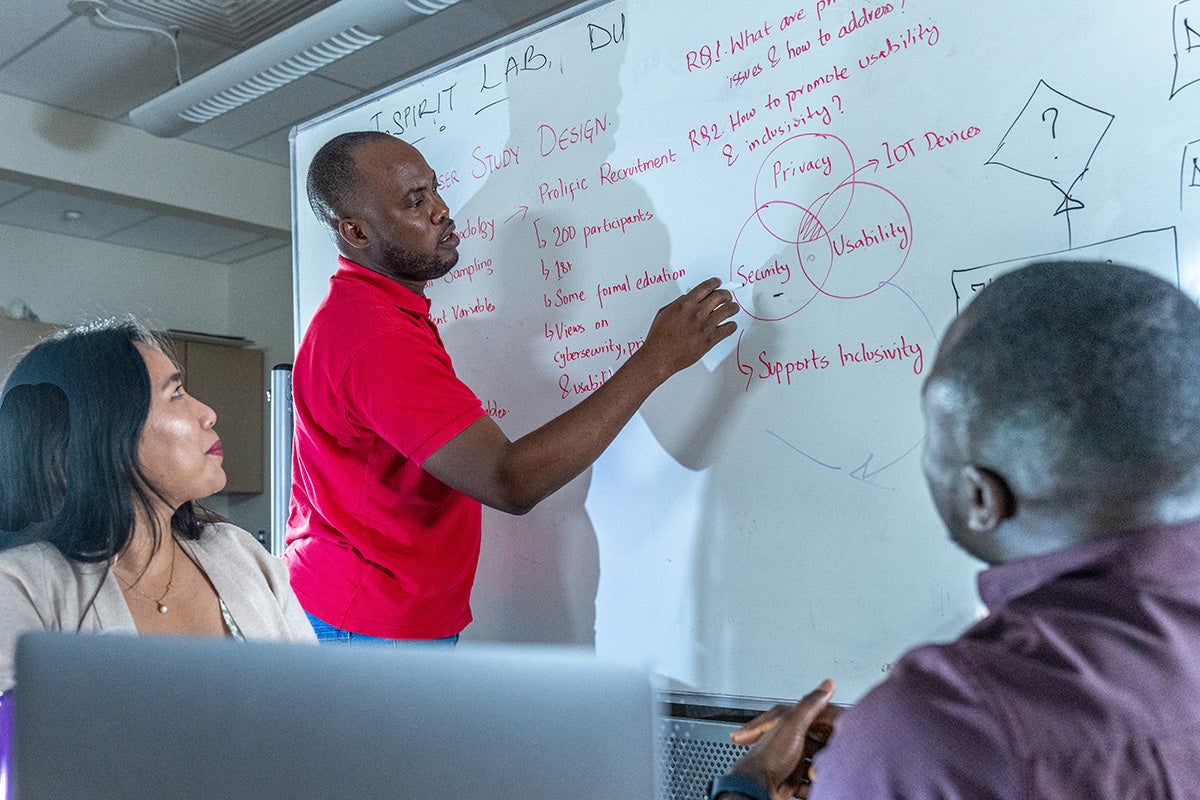 people working on whiteboard