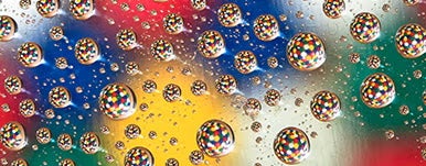 water droplets reflecting colorful background
