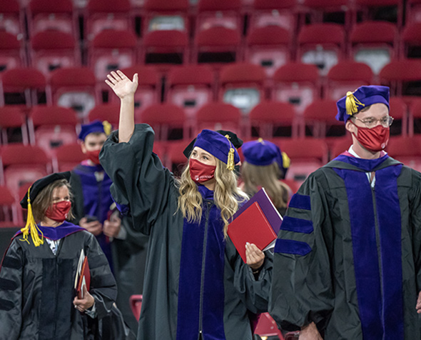 Student waving during law commencement