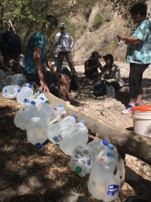 The interterm class stops at a food and water drop on the migrant trail, south of Arivaca, Arizona. 