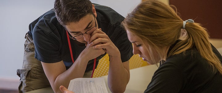 two people looking at documents