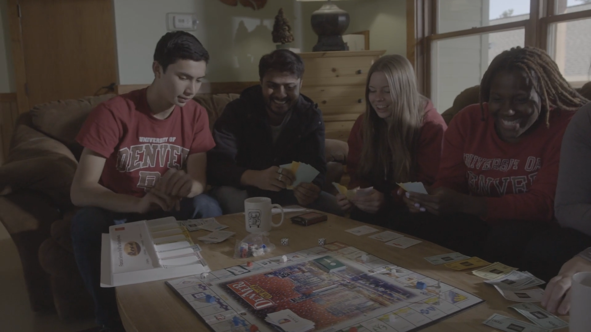 four students playing board game