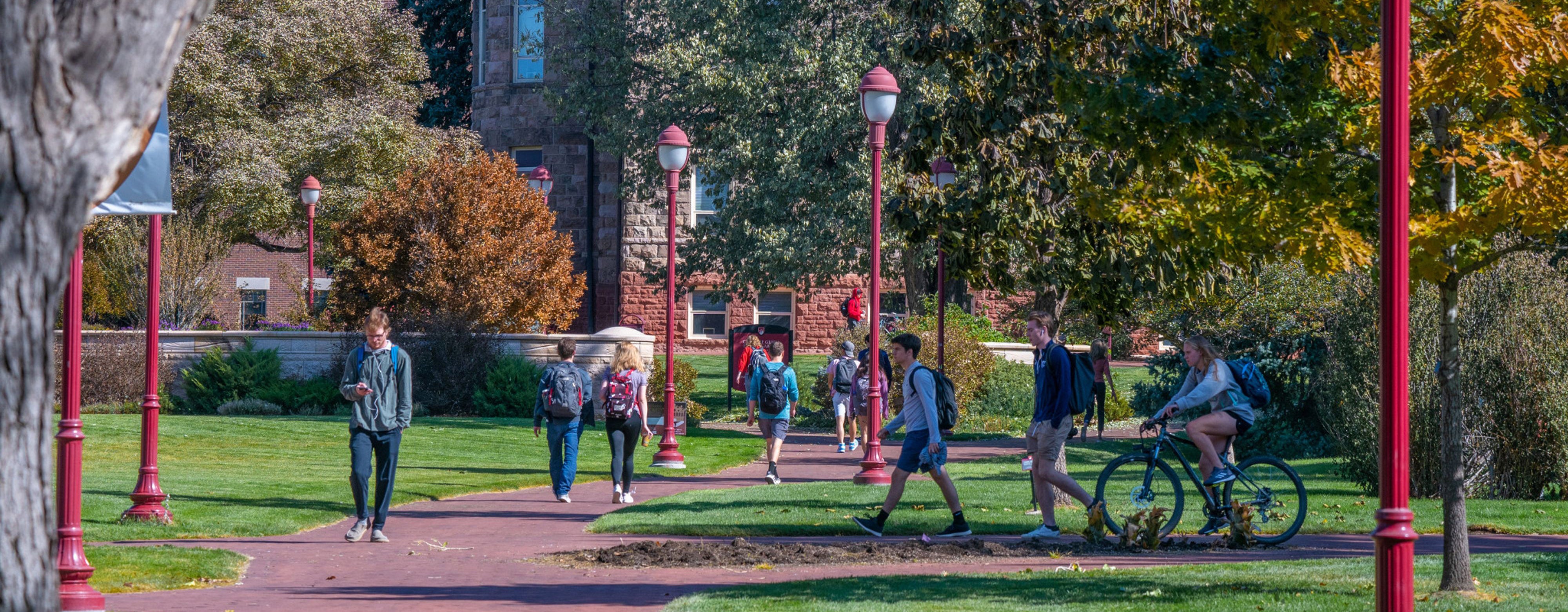 students walking across campus in the fall