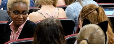 woman looks back at others during lecture