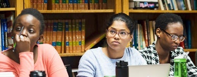 students listen on in a library classroom