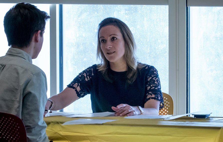 A meeting between two individuals across a table