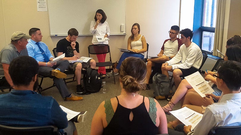 People sitting in a circle doing a deliberation