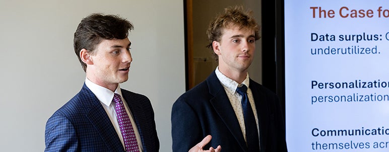 two daniels students doing presentation at case competition