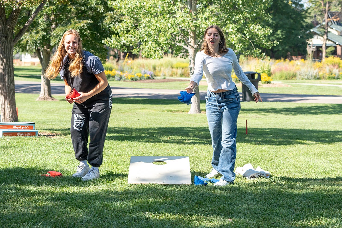 Students playing cornhole at Washington Park
