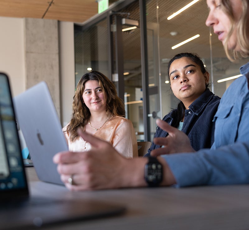 two students and a professor discussing about research