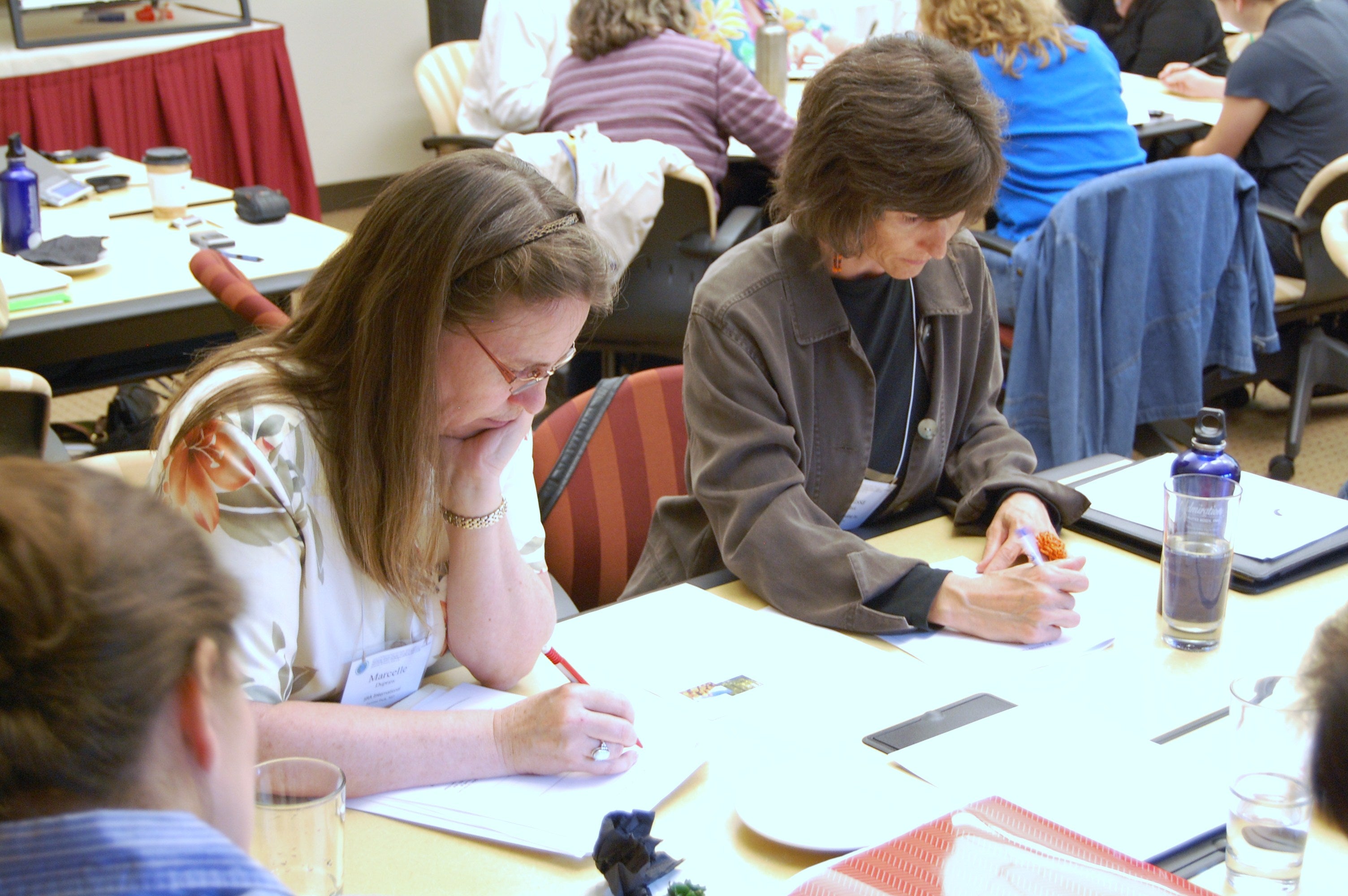 Faculty working at tables