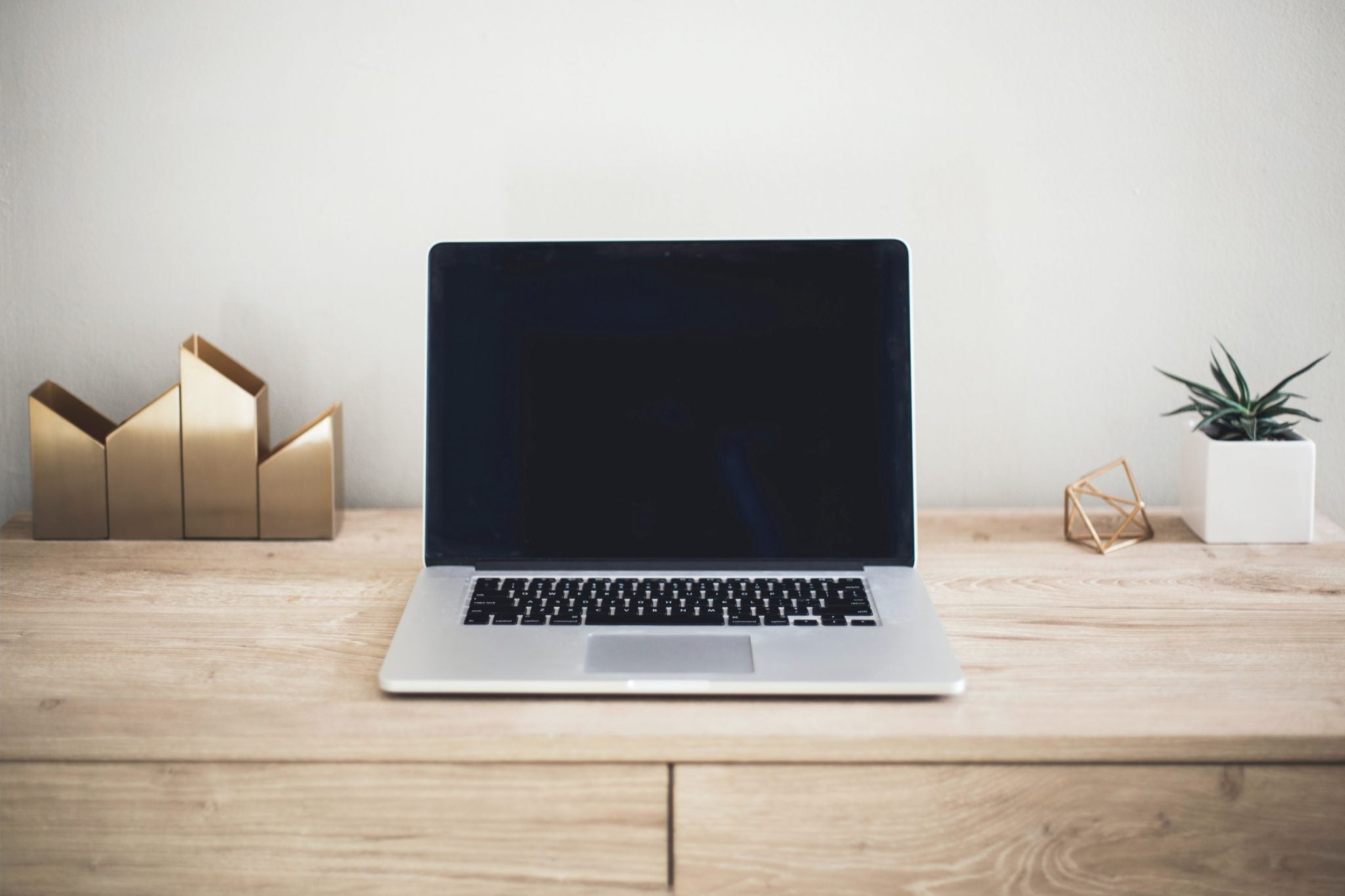laptop sits open on clear desk