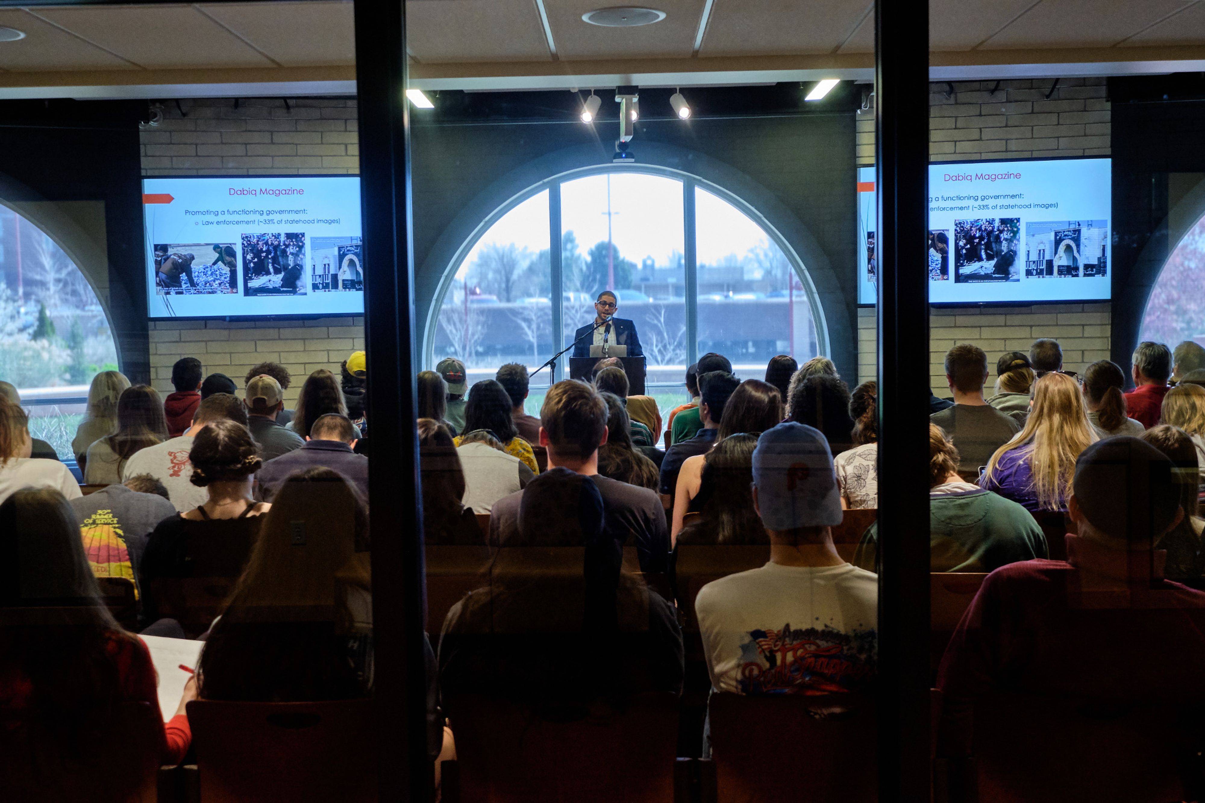 a lecturer presents to a full classroom