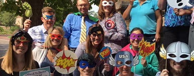 students gathered together for an event with super hero party masks 