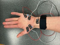 A hand that has wires connected to the palm for electromagnetic reading.