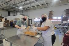 Students from the Fritz Knoebel School of Hospitality Management volunteer at the women's bean project