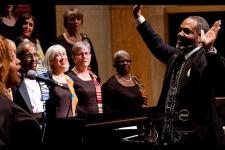 Roger Holland standing in front of choir