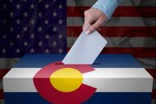hand-puts-ballot-in-colorado-ballot-box
