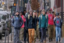 A group of student veterans walk down the street.