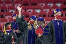 Student waving during law commencement